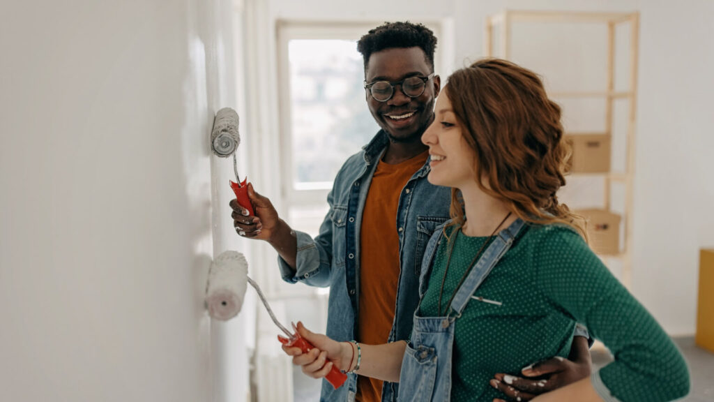 Young couple painting walls